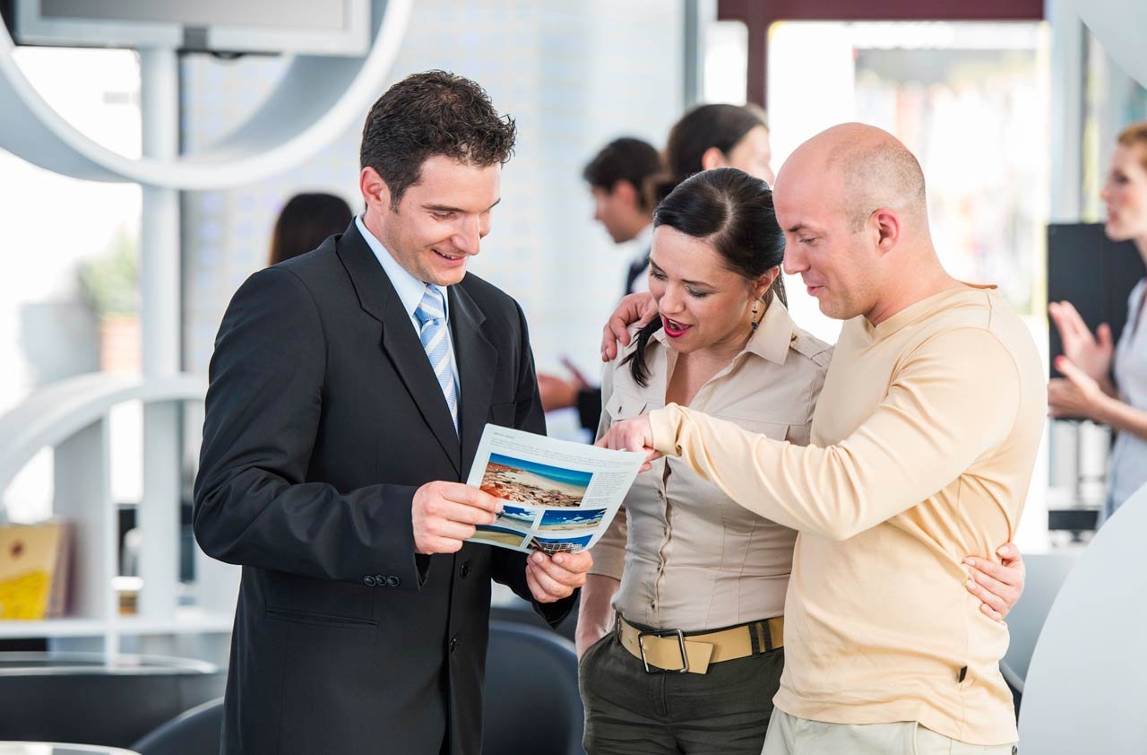 travel agent speaking with tourists